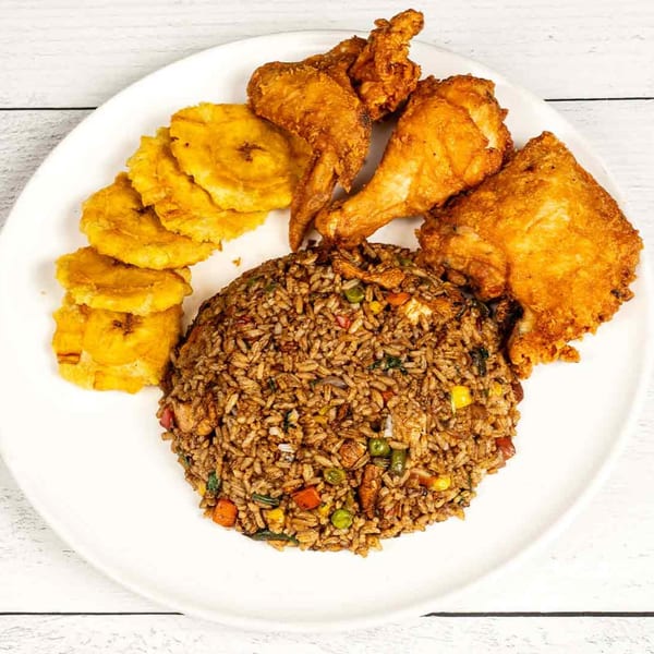 Pollo Lounge and Grill's fried chicken, rice, and plantains on a white plate.